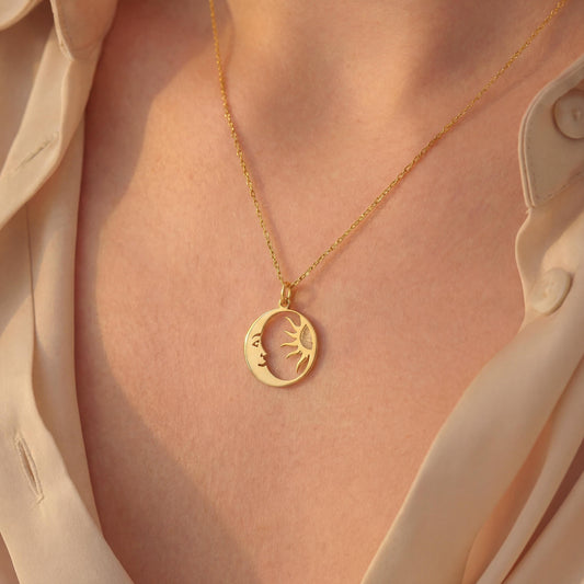 14K gold plated dainty sun and crescent moon face pendant necklace worn by a woman, celestial minimalist boho jewelry.