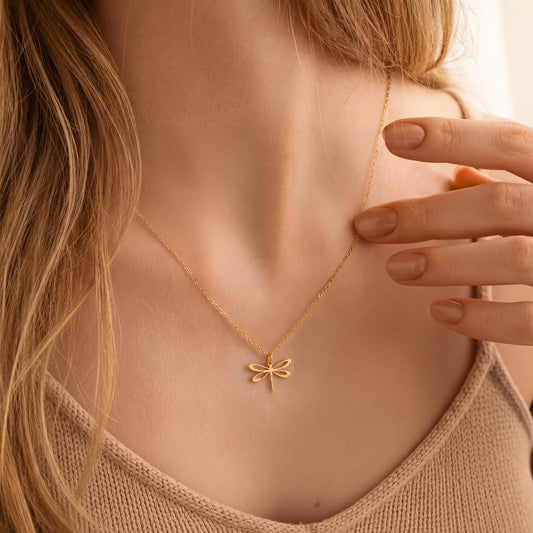 Minimalist 14K gold plated dragonfly necklace worn by a blonde woman, delicate insect pendant resting on collarbone, elegant Mother's Day jewelry gift idea.