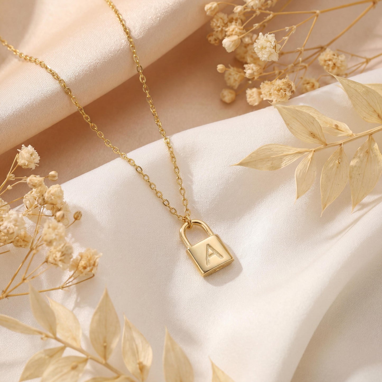 Gold padlock necklace with engraved initial letter A, dainty minimalist personalized jewelry gift for her, Mother's Day custom pendant on model.