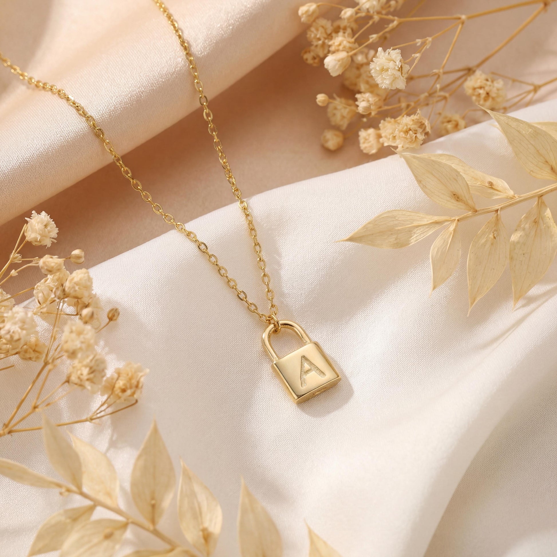 Gold padlock necklace with engraved initial letter A, dainty minimalist personalized jewelry gift for her, Mother's Day custom pendant on model.