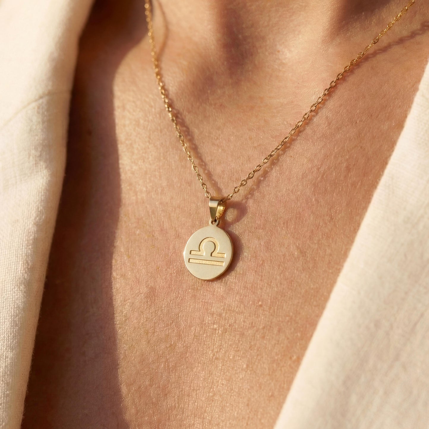 Minimalist round Libra zodiac coin necklace on model, dainty astrology pendant gift for September and October birthdays, celestial jewelry style