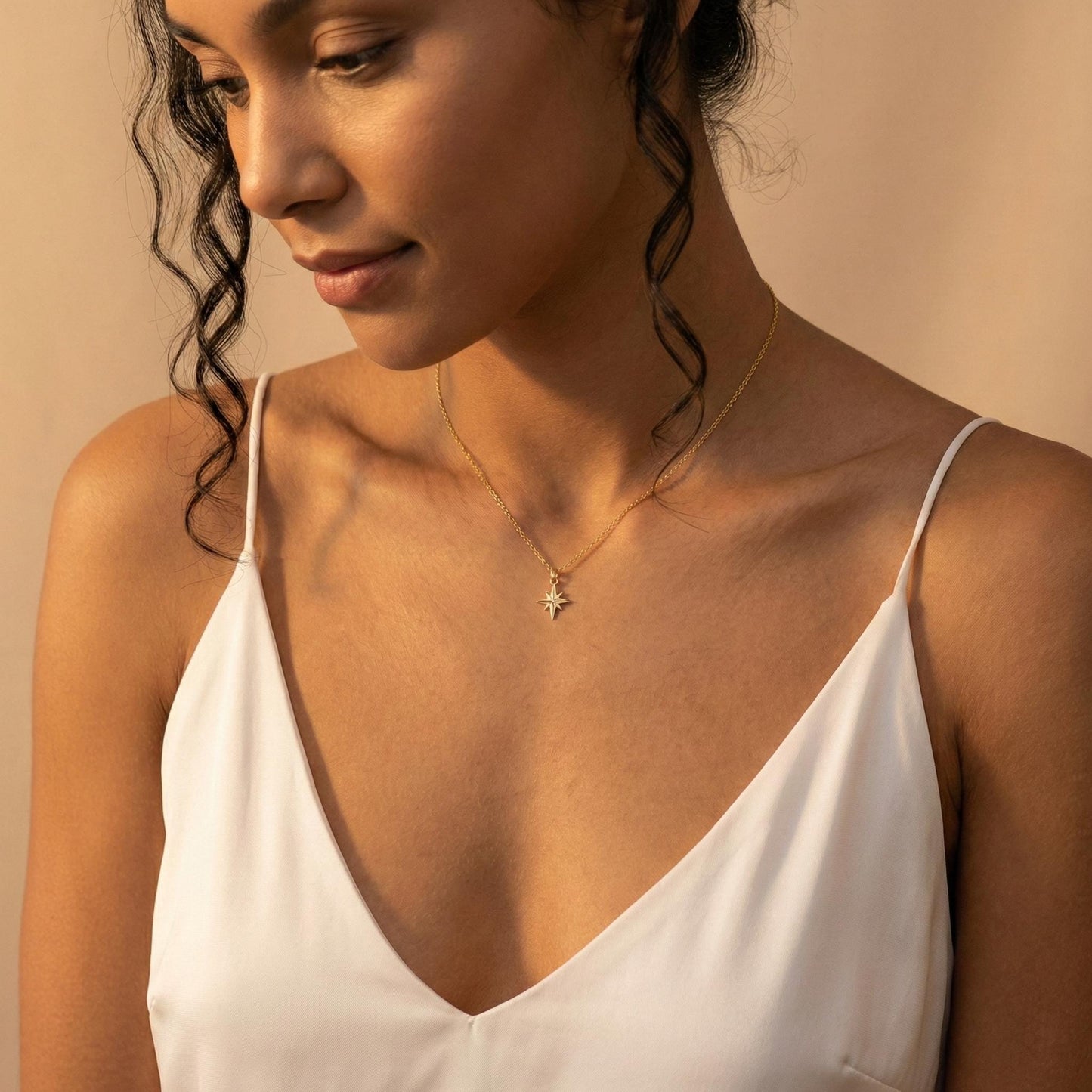 Gold North Star necklace on model, minimalist celestial jewelry pendant, eight-pointed starburst charm necklace, dainty layering necklace gift for her, mothers day and graduation jewelry gift idea