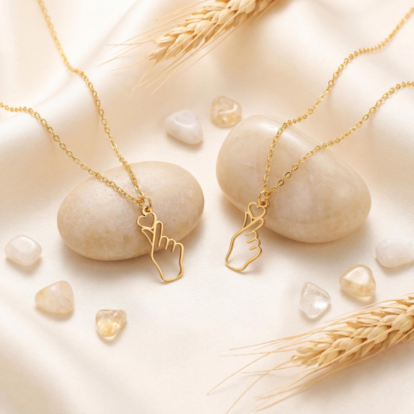 A woman wearing a dainty 14K gold minimalist Korean finger heart necklace, a delicate saranghae hand gesture pendant resting on her collarbone.