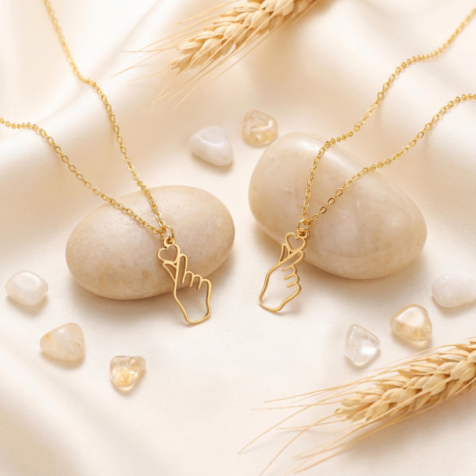A woman wearing a dainty 14K gold minimalist Korean finger heart necklace, a delicate saranghae hand gesture pendant resting on her collarbone.