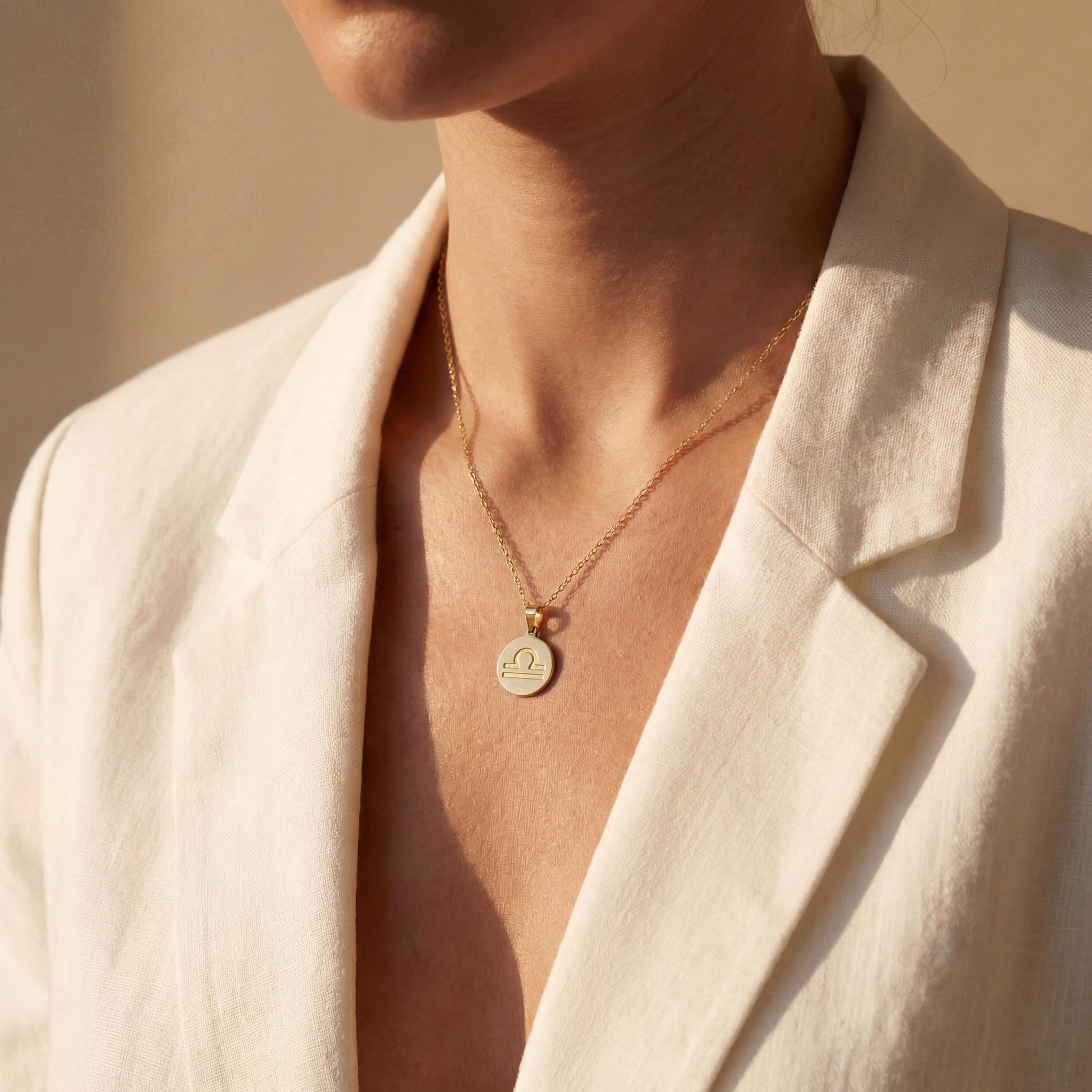 Minimalist round Libra zodiac coin necklace on model, dainty astrology pendant gift for September and October birthdays, celestial jewelry style