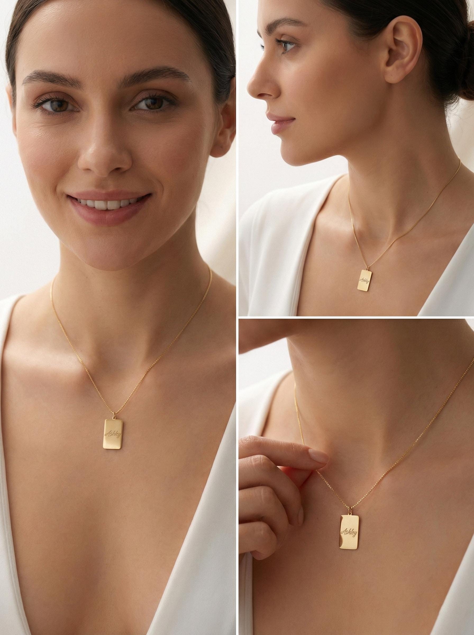 Gold vertical bar necklace on a model's neck, personalized with the engraved name Ashley in cursive font. Minimalist rectangular pendant gift for mother's day.