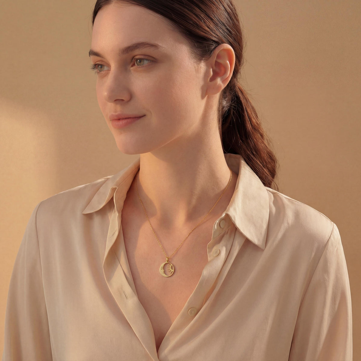 14K gold plated dainty sun and crescent moon face pendant necklace worn by a woman, celestial minimalist boho jewelry.
