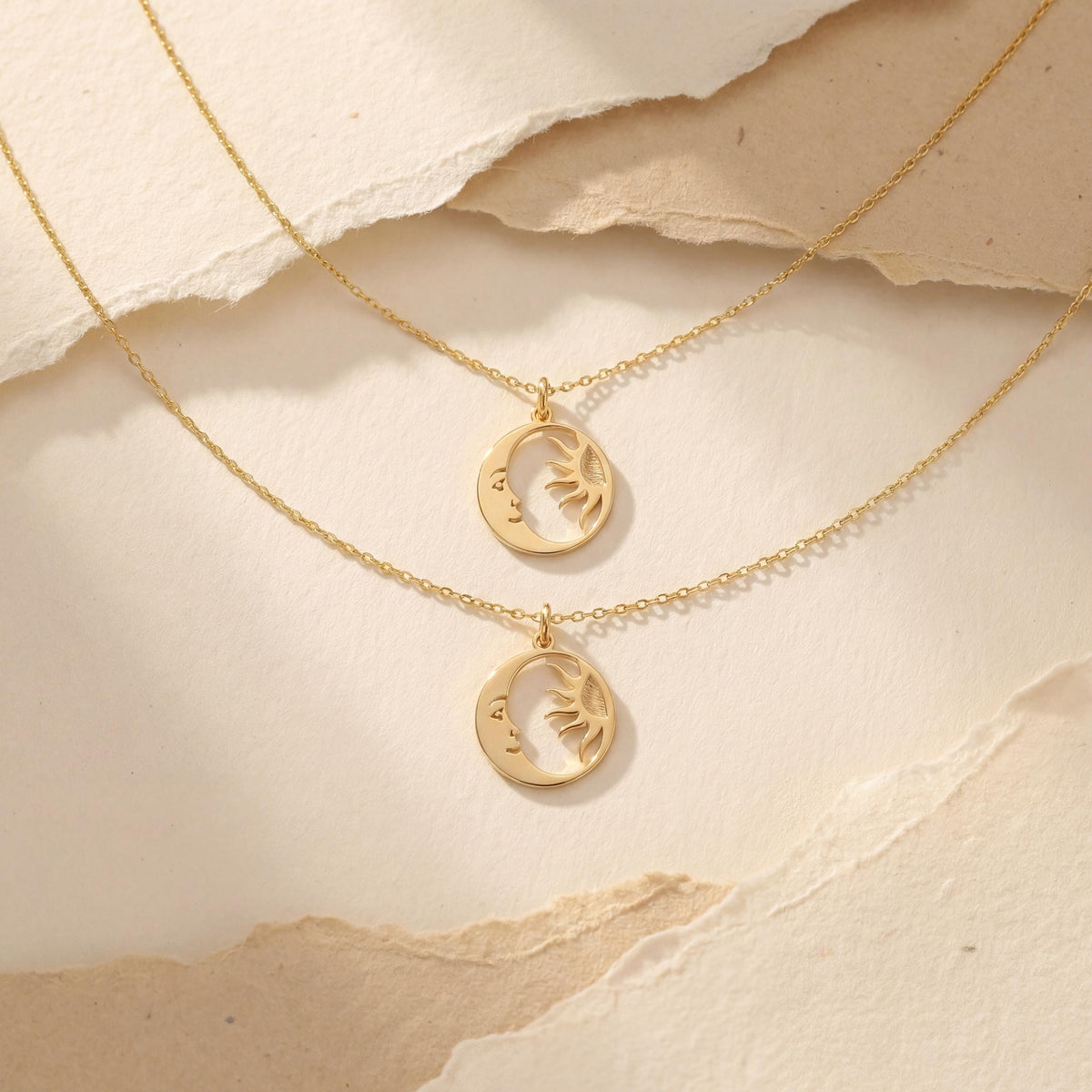 14K gold plated dainty sun and crescent moon face pendant necklace worn by a woman, celestial minimalist boho jewelry.